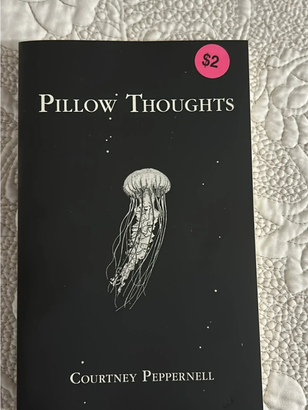 Collection of Decorative Paperback Books in Black, Cream, and Blue